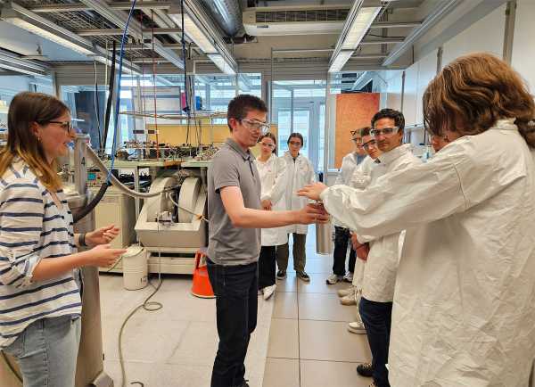 school students in the lab listening to a scientist