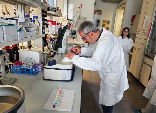 teacher taking a photograph of a scientific setting